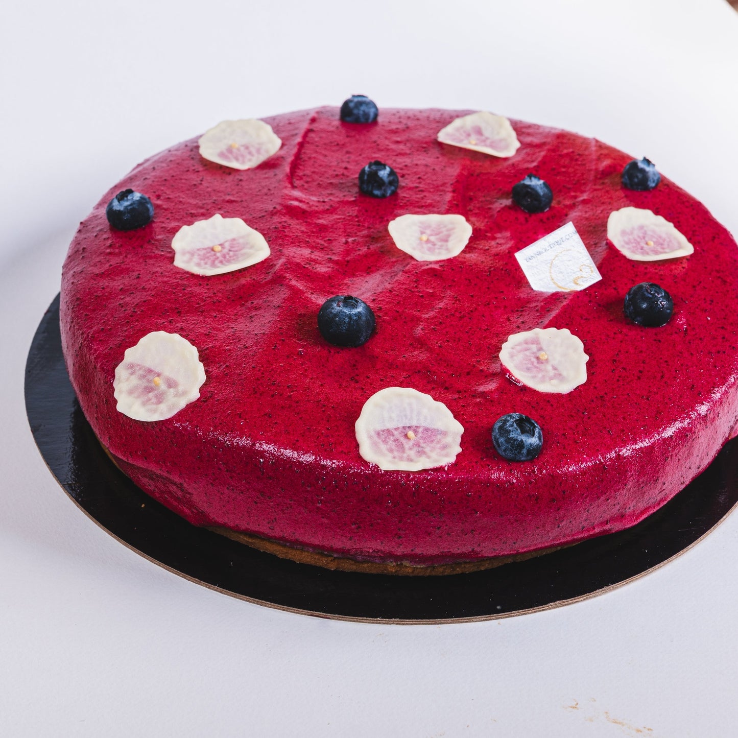Almond & lemon cake, lemon cremeux with blackcurrant compote, soft blackcurrant meringue on top! Yann Haute Patisserie authentic French Pastry shop in a yellow house in Calgary for the best cakes, croissants, bread & desserts. Delivery and free parking!