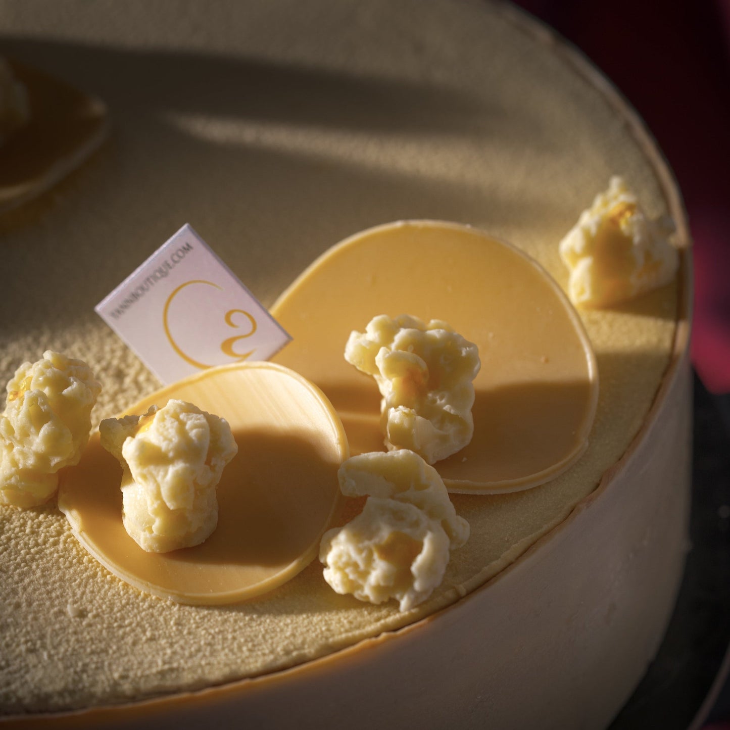 Three Father's Day desserts inspired by movie-night popcorn including a cake, chocolate treat in cloche, and caramel popcorn croissant.