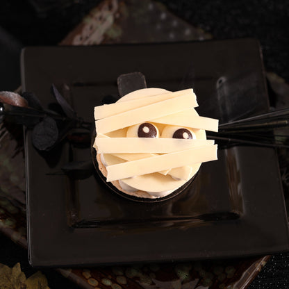 Mummy-shaped Halloween dessert with exotic mango passion fruit, vanilla mascarpone cream and white chocolate.