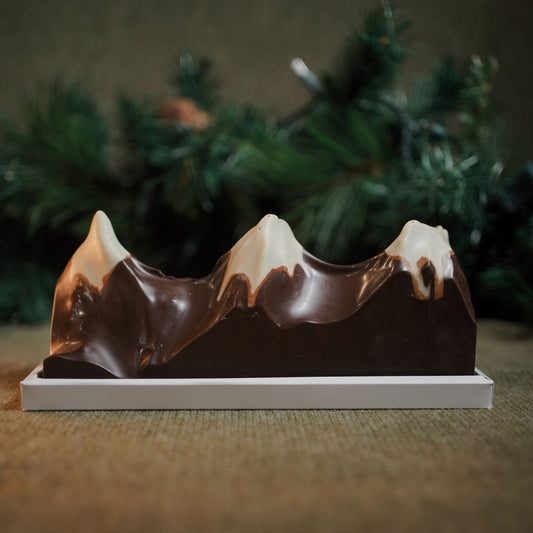 A sculptural chocolate centrepiece blending deep Valrhona Ghana dark chocolate with crisp, creamy hazelnut praliné peaks. Created by our pastry team as an edible homage to the Three Sisters — perfect for gifting, sharing, or celebrating special moments.
