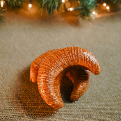 Golden flaky croissant with creamy rice pudding filling and caramel drizzle.