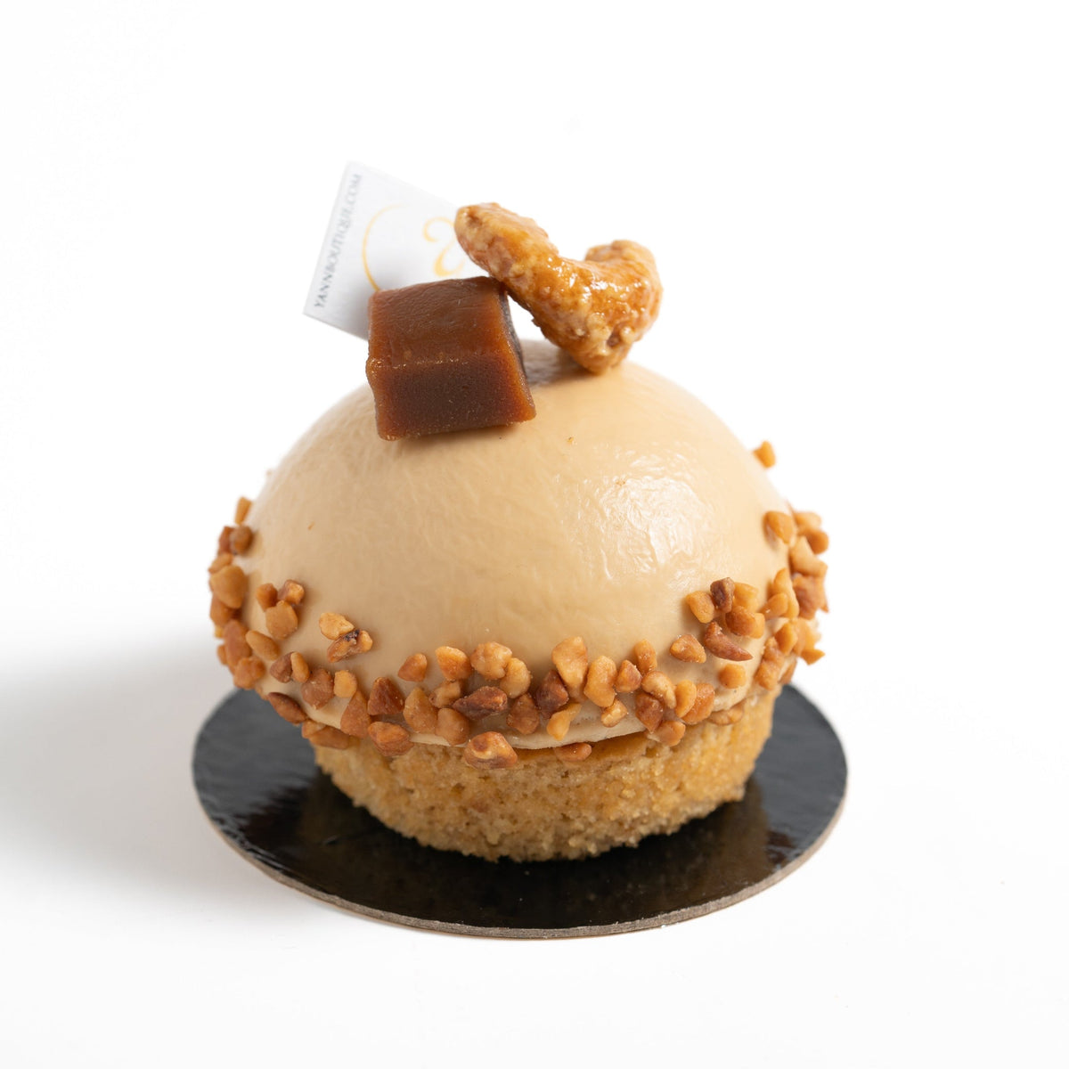 Elegant Dulcey chocolate cake layered with cashew caramel, vanilla bean salted caramel and cashew vanilla cremeux.
