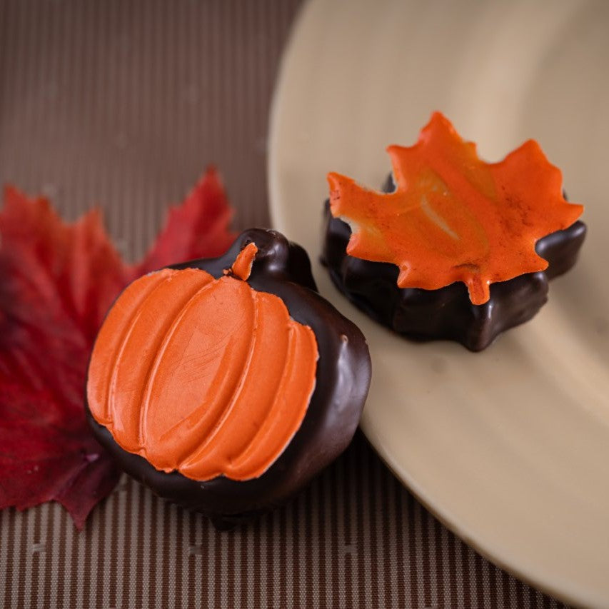 Thanksgiving chocolate individual desserts decorated with orange pumpkin and maple leaf details from Yann Haute Patisserie in Calgary.