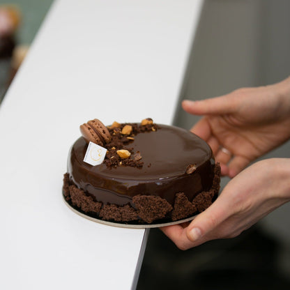 Handcrafted French chocolate cake featuring rich Valrhona dark chocolate and hazelnut crunch at Yann Haute Patisserie.